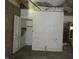 Photo showing a room with damaged walls, exposed beams, and deteriorating ceiling, reflecting a renovation in progress at 425 N Grant Ave, Indianapolis, IN 46201