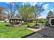 Picturesque backyard with gazebo, patio set, lush lawn, and mature trees, perfect for outdoor relaxation and entertaining at 4337 Lincoln Rd, Indianapolis, IN 46228
