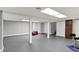 A spacious basement featuring gray walls, flooring, support beams and bright lighting creating a versatile living space at 4337 Lincoln Rd, Indianapolis, IN 46228