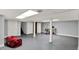 Spacious basement with gray painted walls and floors, bright lighting, with possible office and storage space at 4337 Lincoln Rd, Indianapolis, IN 46228