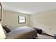 Sunlit bedroom with plush carpet, cozy queen sized bed, and ample natural light for a serene experience at 4337 Lincoln Rd, Indianapolis, IN 46228