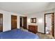 Bedroom features a bed, carpet, dresser, and doorways to closets and the ensuite bathroom at 4337 Lincoln Rd, Indianapolis, IN 46228