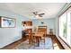 Dining room features a ceiling fan, large window, wooden furniture, and decorative rug at 4337 Lincoln Rd, Indianapolis, IN 46228