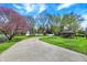 Scenic driveway leading to a home with a gazebo and flowering trees at 4337 Lincoln Rd, Indianapolis, IN 46228