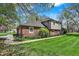 Brick and shingle siding accents this home with a manicured green lawn at 4337 Lincoln Rd, Indianapolis, IN 46228