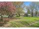 Charming two-story brick home with a lush green front yard, mature trees, and inviting curb appeal at 4337 Lincoln Rd, Indianapolis, IN 46228