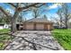 Two-car garage exterior highlighting brick facade and ample parking space with mature trees at 4337 Lincoln Rd, Indianapolis, IN 46228
