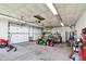 Spacious two-car garage featuring storage and ample room for a vehicle and lawn equipment at 4337 Lincoln Rd, Indianapolis, IN 46228
