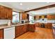 Open kitchen boasts wooden cabinetry, granite countertops, hardwood floors, and stainless steel appliances at 4337 Lincoln Rd, Indianapolis, IN 46228