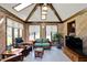 Bright sunroom with beamed ceiling, skylights, and a cozy seating area at 4337 Lincoln Rd, Indianapolis, IN 46228