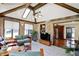 Spacious sunroom with skylights, wood paneling, tile floors, and access to other living areas at 4337 Lincoln Rd, Indianapolis, IN 46228
