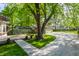 Lush backyard with garage, a patio dining set, and mature trees providing ample shade at 4343 N Pennsylvania St, Indianapolis, IN 46205