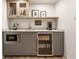 Basement bar area featuring grey cabinets, stainless steel appliances, and a beverage fridge at 4343 N Pennsylvania St, Indianapolis, IN 46205