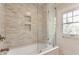 Bathroom featuring a tiled shower, soaker tub, and a window at 4343 N Pennsylvania St, Indianapolis, IN 46205