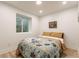 Cozy bedroom featuring a comfortable bed with colorful quilt and natural light from a window at 4343 N Pennsylvania St, Indianapolis, IN 46205