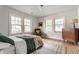 Bright bedroom featuring hardwood floors, a sitting chair, and neutral colors at 4343 N Pennsylvania St, Indianapolis, IN 46205