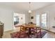 Dining room with wood floors, round wood table, rug and a view into another room at 4343 N Pennsylvania St, Indianapolis, IN 46205