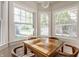 Bright eating area with brick floors, wood table and chairs, and multiple windows at 4343 N Pennsylvania St, Indianapolis, IN 46205