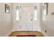 Bright entryway with hardwood floors, paneled front door with sidelights, and classic decor at 4343 N Pennsylvania St, Indianapolis, IN 46205