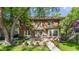 Charming two-story brick home with well-manicured landscaping and inviting outdoor patio area at 4343 N Pennsylvania St, Indianapolis, IN 46205