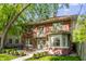 Two-story brick home featuring a quaint balcony, bay window, and outdoor patio area at 4343 N Pennsylvania St, Indianapolis, IN 46205