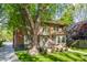Charming two-story brick home with well-manicured landscaping and inviting outdoor patio area at 4343 N Pennsylvania St, Indianapolis, IN 46205