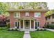 Charming two-story brick home featuring a red tile roof, covered porch, and well-manicured lawn at 4343 N Pennsylvania St, Indianapolis, IN 46205