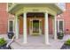 Close-up of the home's covered front porch, showcasing its columns and potted plants by the door at 4343 N Pennsylvania St, Indianapolis, IN 46205