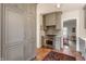 Kitchen with stainless steel appliances, gray cabinets, brick floors and view into other rooms at 4343 N Pennsylvania St, Indianapolis, IN 46205