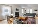 Sunlit living room with a fireplace, modern sofa, and view of the backyard at 4343 N Pennsylvania St, Indianapolis, IN 46205
