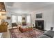 Comfortable living room with a fireplace, shelving unit, and plenty of natural light at 4343 N Pennsylvania St, Indianapolis, IN 46205
