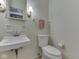 Powder room featuring a sink, mirror, toilet and towel rack at 4412 Mountbatten Ct, Indianapolis, IN 46254