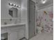 Bathroom with light grey walls, decorative fixtures, vanity and shower at 4412 Mountbatten Ct, Indianapolis, IN 46254
