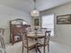 Dining area with a wooden table set, a decorative chandelier, and a china cabinet at 4412 Mountbatten Ct, Indianapolis, IN 46254