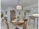 Open dining area featuring a wooden table set adjacent to the kitchen bar at 4412 Mountbatten Ct, Indianapolis, IN 46254