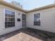 Inviting side entrance with secure door, brick patio and ample natural light at 4412 Mountbatten Ct, Indianapolis, IN 46254
