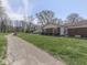 Charming home nestled on a grassy lot with mature trees and a side driveway at 4412 Mountbatten Ct, Indianapolis, IN 46254