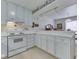 Bright kitchen featuring white cabinetry, modern appliances, and a view into dining area at 4412 Mountbatten Ct, Indianapolis, IN 46254