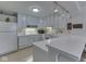 Bright kitchen featuring white cabinetry, countertops, and modern appliances at 4412 Mountbatten Ct, Indianapolis, IN 46254