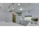 View of kitchen with white appliances, tile countertops, and an eat-in bar at 4412 Mountbatten Ct, Indianapolis, IN 46254