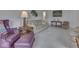Cozy living room with neutral carpet, sofa, purple chairs, and ample natural light at 4412 Mountbatten Ct, Indianapolis, IN 46254