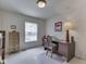 Office with large window, desk, wooden chair, and decor at 4412 Mountbatten Ct, Indianapolis, IN 46254