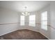Bright dining room with a decorative chandelier and plenty of natural light from the large windows at 4545 Connaught East Dr, Plainfield, IN 46168