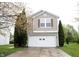 Charming home featuring a two-car garage and a well-maintained front yard with mature landscaping at 4545 Connaught East Dr, Plainfield, IN 46168