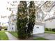 Inviting side view of a home showcasing lush landscaping and an attached two-car garage at 4545 Connaught East Dr, Plainfield, IN 46168