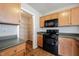 Kitchen with stainless steel appliances and wooden cabinets, providing ample storage and workspace at 4545 Connaught East Dr, Plainfield, IN 46168