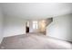 Expansive living area featuring soft carpeting, neutral tones, and a seamless transition to the kitchen at 4545 Connaught East Dr, Plainfield, IN 46168
