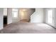 Bright and airy living room offering plush carpeting, and convenient access to the entryway and backyard at 4545 Connaught East Dr, Plainfield, IN 46168