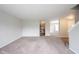 Comfortable living room with soft carpeting, neutral walls, and views into the kitchen and dining area at 4545 Connaught East Dr, Plainfield, IN 46168