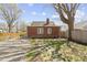 Backyard showing the brick home, partial driveway, lawn, and fencing at 4640 Boulevard Pl, Indianapolis, IN 46208